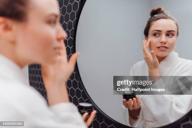 young woman having skin routine. - soin de la peau photos et images de collection
