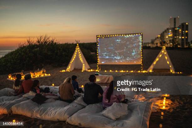 group of people watching a movie at the outdoors cinema - outdoor film screening stock pictures, royalty-free photos & images