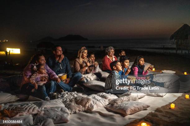 group of people watching a movie at the outdoors cinema - cinema screen stock pictures, royalty-free photos & images