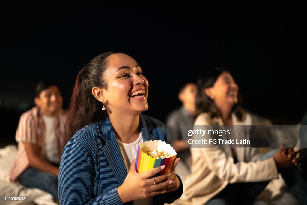 Young woman watching a movie. at the outdoors cinema