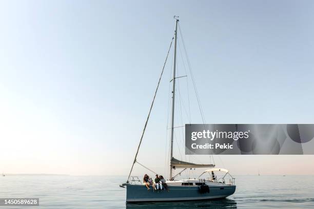 friends riding on a yacht together - sail stock pictures, royalty-free photos & images