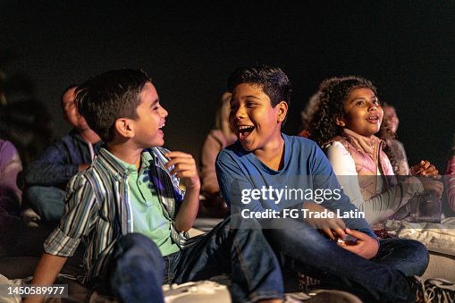 Children talking and laughing at the outdoors cinema