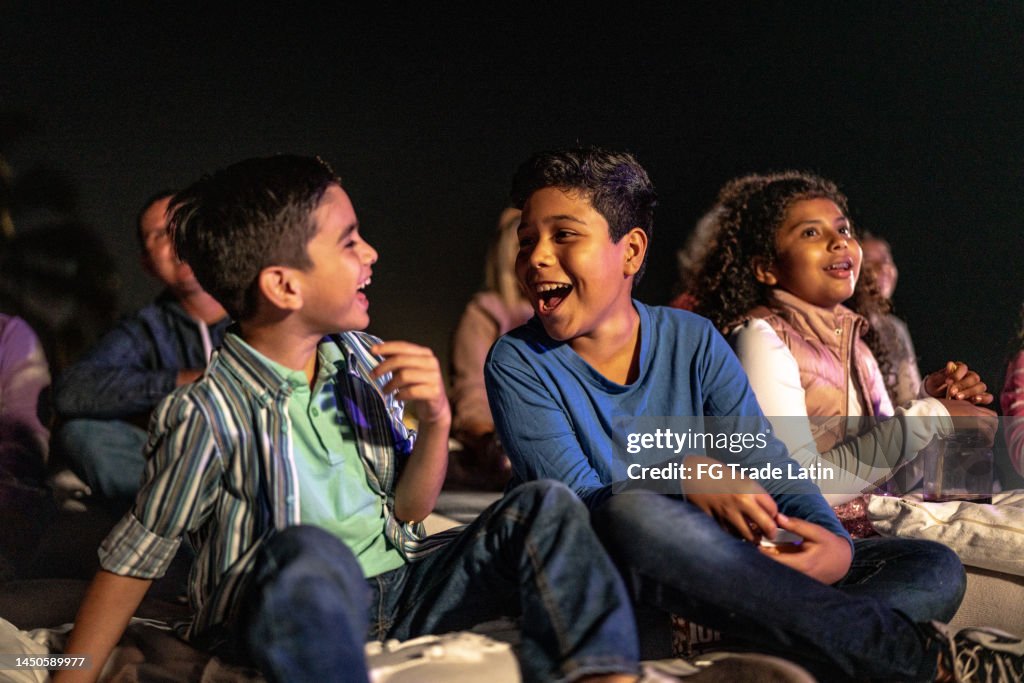 Children talking and laughing at the outdoors cinema