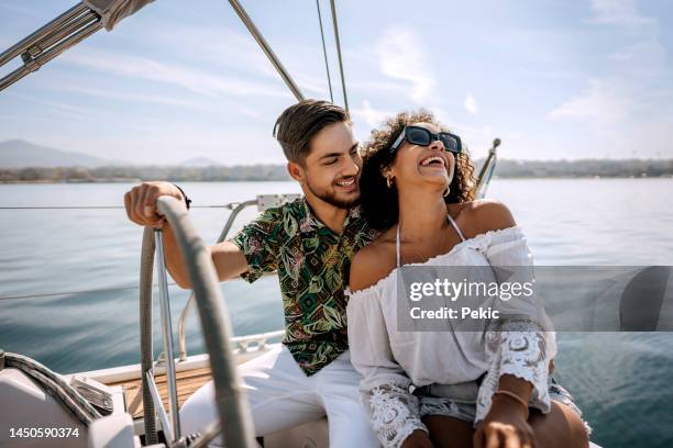 young couple enjoying their vacation on the yacht - sailing greece stock pictures, royalty-free photos & images