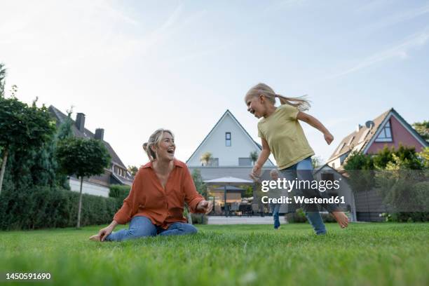 happy woman with daughter and son enjoying in back yard - family backyard imagens e fotografias de stock