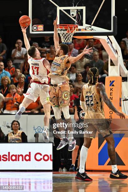 Michael Harris of the Wildcats goes for the basket under pressure from DJ Hogg of the Taipans during the round 11 NBL match between Cairns Taipans...