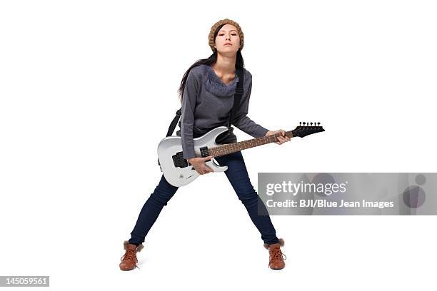 stylish young woman playing guitar - playing electric guitar stock-fotos und bilder