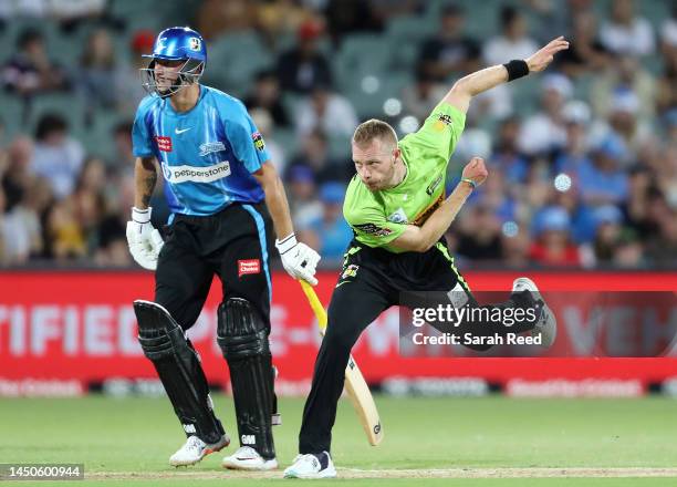 Nathan McAndrew of the Thunder and Matt Short of the Strikers during the Men's Big Bash League match between the Adelaide Strikers and the Sydney...