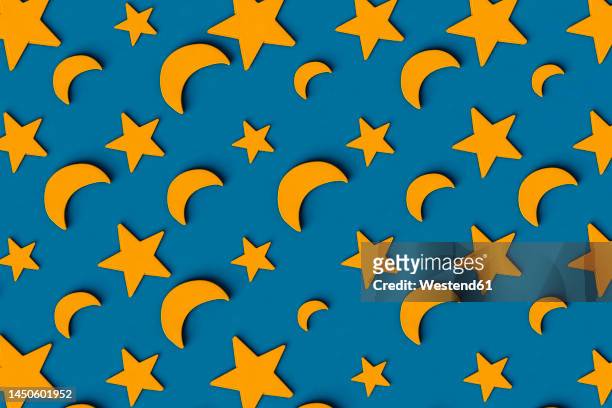 three dimensional pattern of rows of yellow stars and crescent moons flat laid against blue background - flat lay stock illustrations