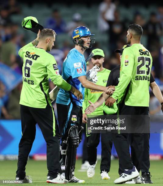 Adam Hose of the Strikers with Alex Hales of the Thunder and Jason Sangha of Sydney Thunder after the match during the Men's Big Bash League match...