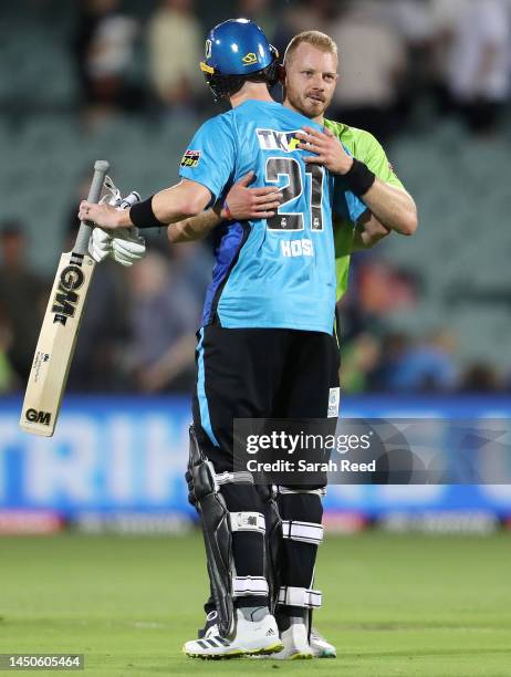 Adam Hose of the Strikers and Nathan McAndrew of the Thunder during the Men's Big Bash League match between the Adelaide Strikers and the Sydney...