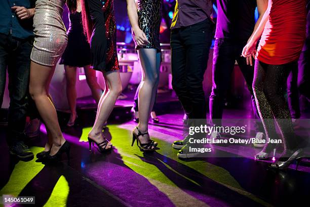 stylish young people dancing in nightclub - teenage girl club stock-fotos und bilder