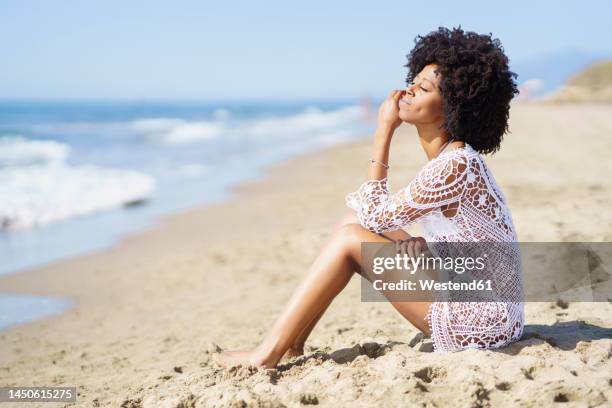 young woman with eyes closed sitting on beach - lace dress stock pictures, royalty-free photos & images