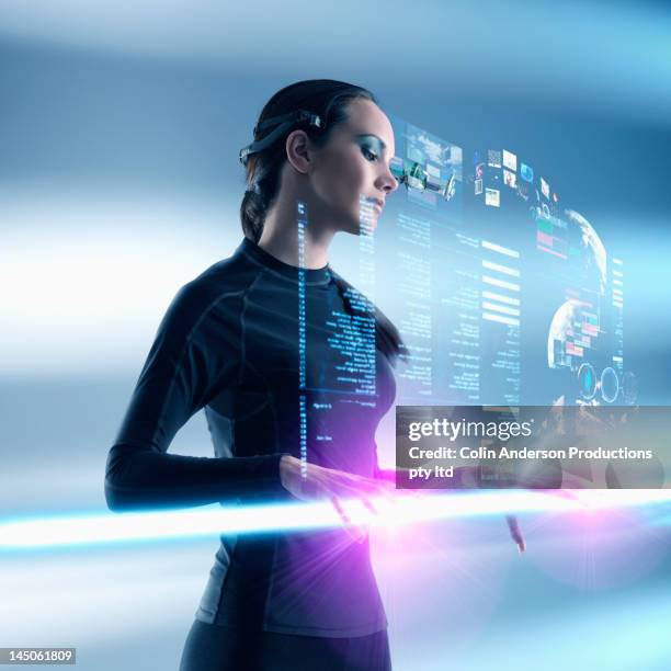 futuristic pacific islander woman using digital screen - hologramme photos et images de collection