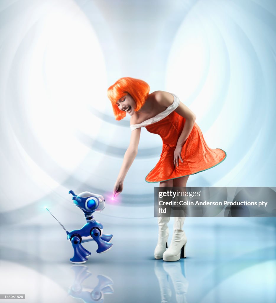 Futuristic Pacific Islander woman playing with robot dog