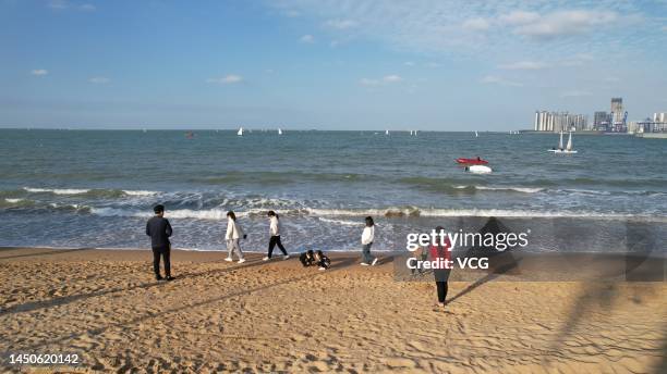 Aerial view of people watching sailboats on the sea at a sailing training base off the West Coast of Haikou on December 19, 2022 in Haikou, Hainan...