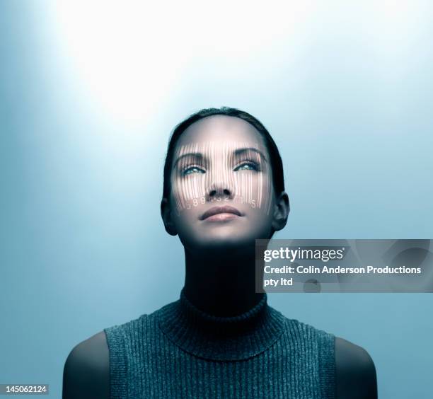 pacific islander woman with shadow of bar code on her face - barcode scanner stock-fotos und bilder