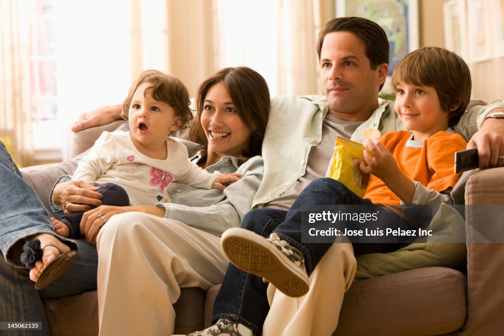 Caucasian family watching television together