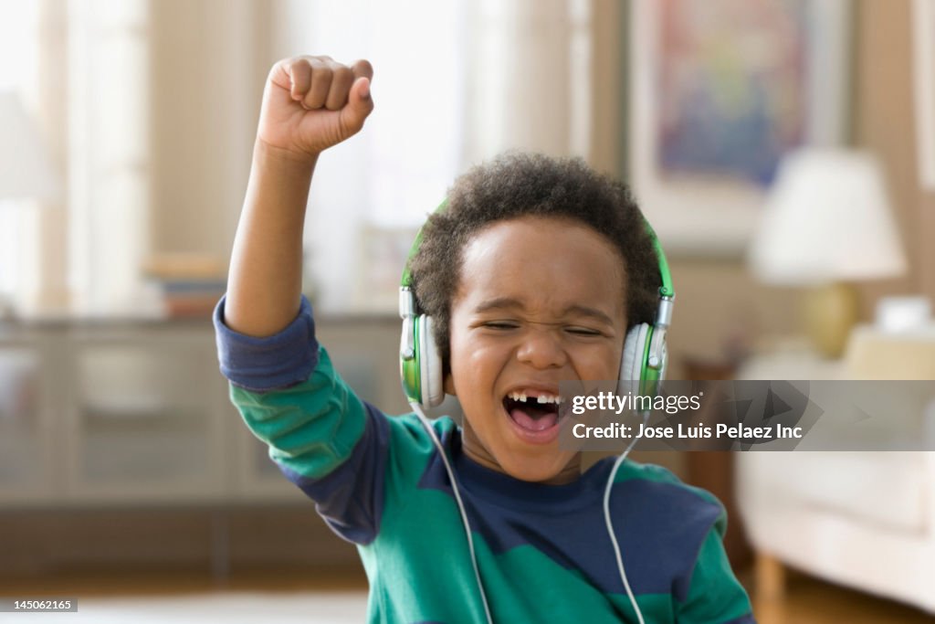 Black boy listening to music on headphones