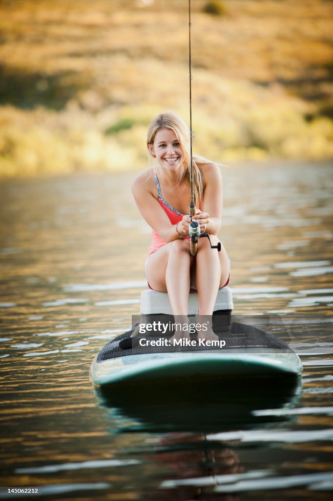 Caucasian woman fishing in lake