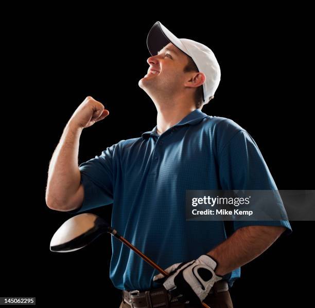 cheering golfer holding golf club - playing to win ストックフォトと画像