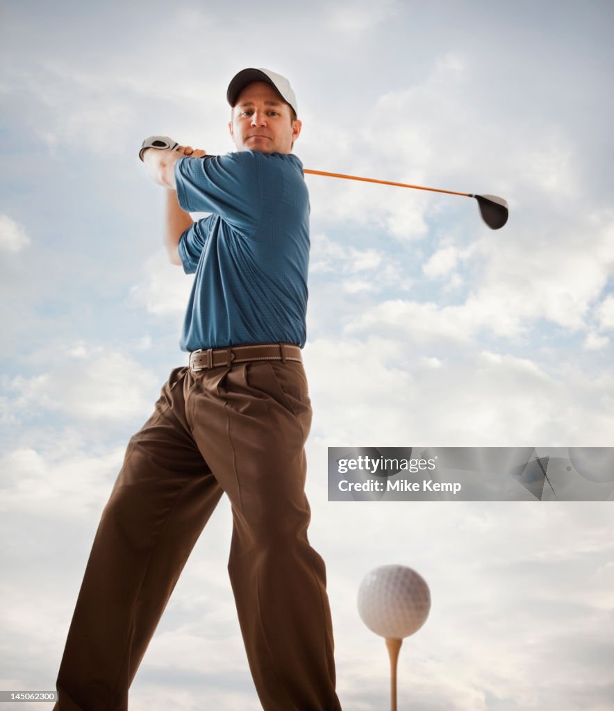 Caucasian golfer about to swing golf club