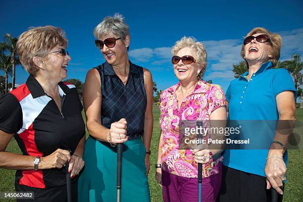 senior caucasian women playing golf - golf short iron stock pictures, royalty-free photos & images