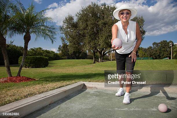 senior caucasian woman playing bocce ball - bocce ball stock pictures, royalty-free photos & images