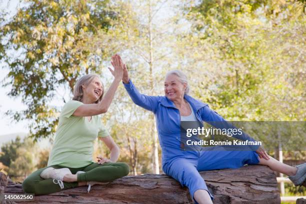 caucasian woman high-fiving outdoors - trust exercise stock pictures, royalty-free photos & images