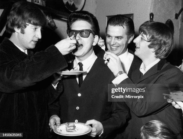 Roy Orbison being fed birthday cake by John Lennon while Ringo Starr looks on. It was Roy's 28th birthday party and a party was thrown in London....