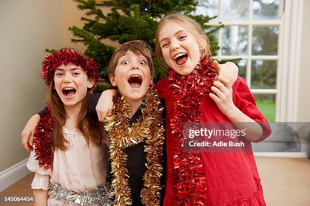 children playing with christmas tinsel - female bush photos stockfoto's en -beelden