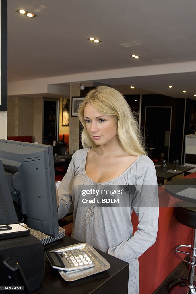 Hostess using computer in restaurant