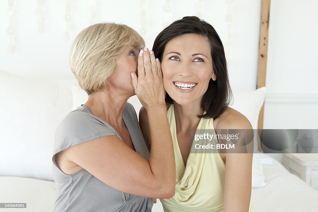Women whispering to each other