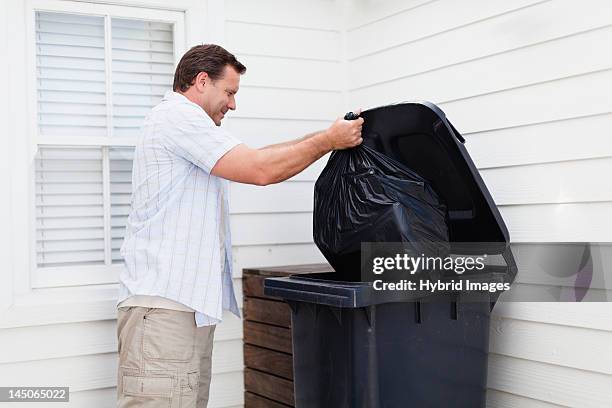 man taking out garbage - taking stock pictures, royalty-free photos & images