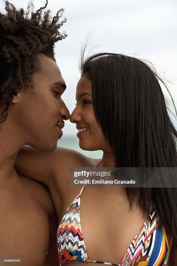 A young couple with arms around each other