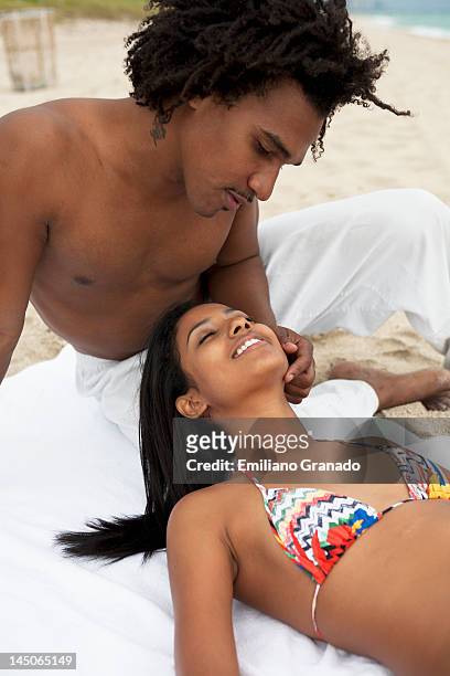 an affectionate young couple at the beach - hot puerto rican women stock-fotos und bilder