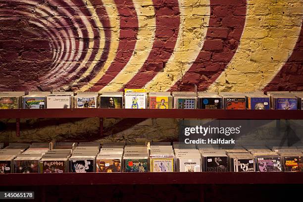 shelves of compact discs in a record shop - colorful cd photos et images de collection