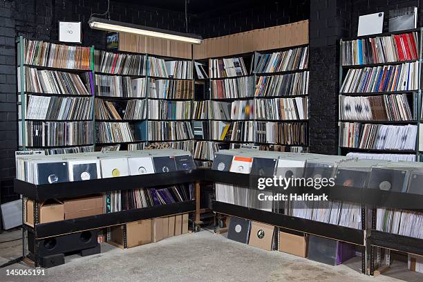 rows of records on shelves and in bins at a record store - plattenladen stock-fotos und bilder