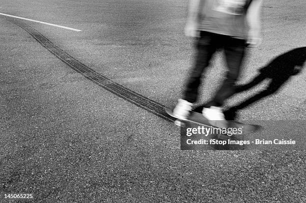 a skateboarder leaving tire tracks - skid marks fotografías e imágenes de stock