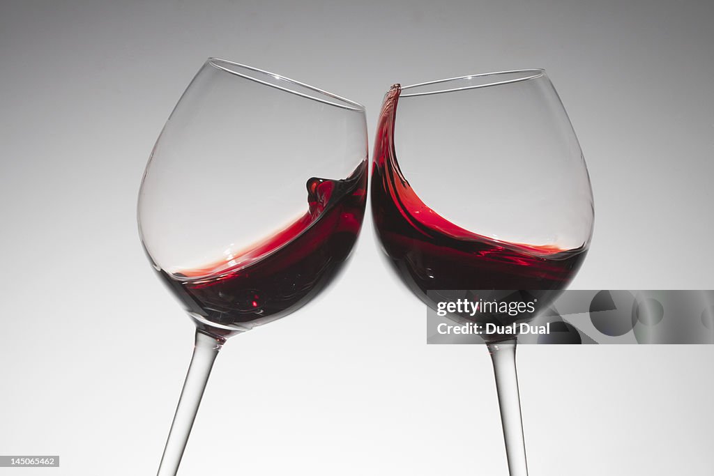 Toasting with two glasses of red wine