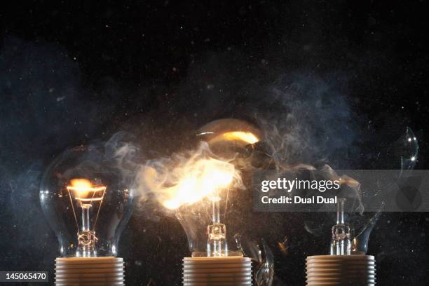 burning and exploding light bulbs - exploding lightbulb stock pictures, royalty-free photos & images