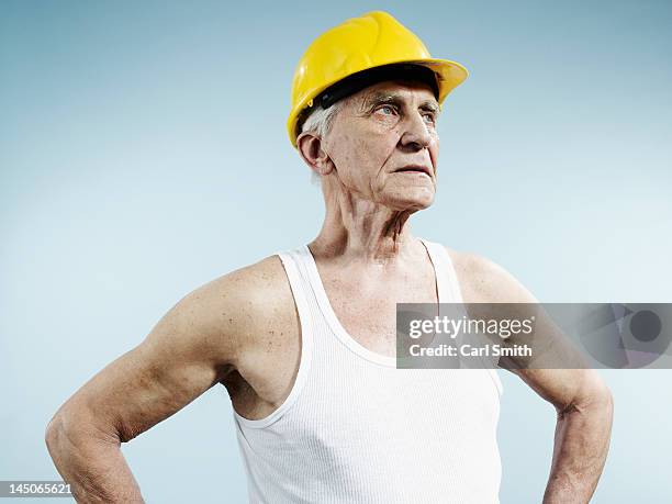 a senior man wearing a hardhat and tank top - vest stock pictures, royalty-free photos & images