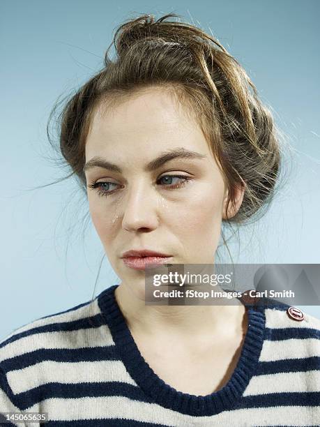 a woman with tears running down her face - studio shot lonely woman stock pictures, royalty-free photos & images