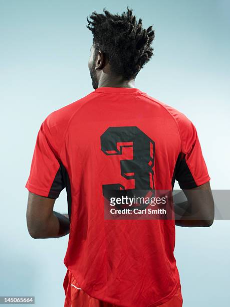 a man wearing a numbered soccer shirt - strip foto e immagini stock