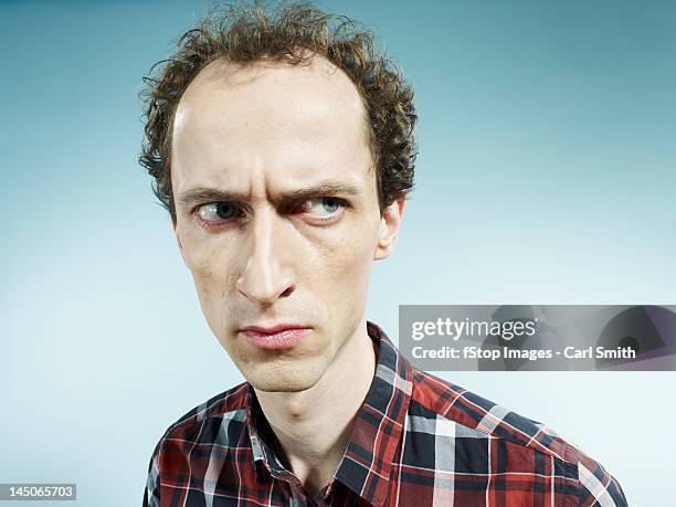 a man looking suspiciously to the side - angry man pose stock pictures, royalty-free photos & images