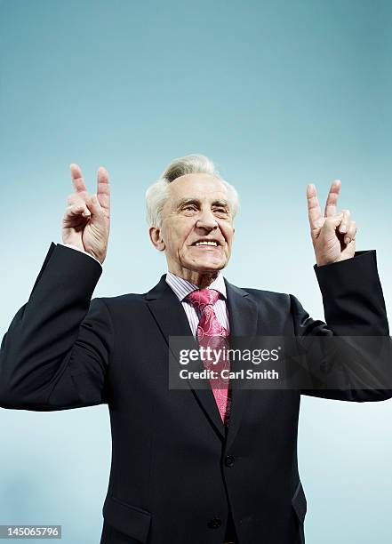 a senior man with both hands raised making peace signs - special jurisdiction for peace stock pictures, royalty-free photos & images