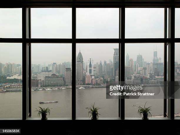 shanghai skyline seen through window - cloudy day office building stockfoto's en -beelden
