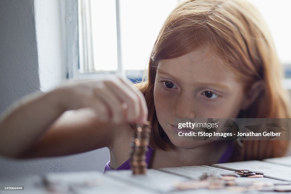 Girl stacking coins