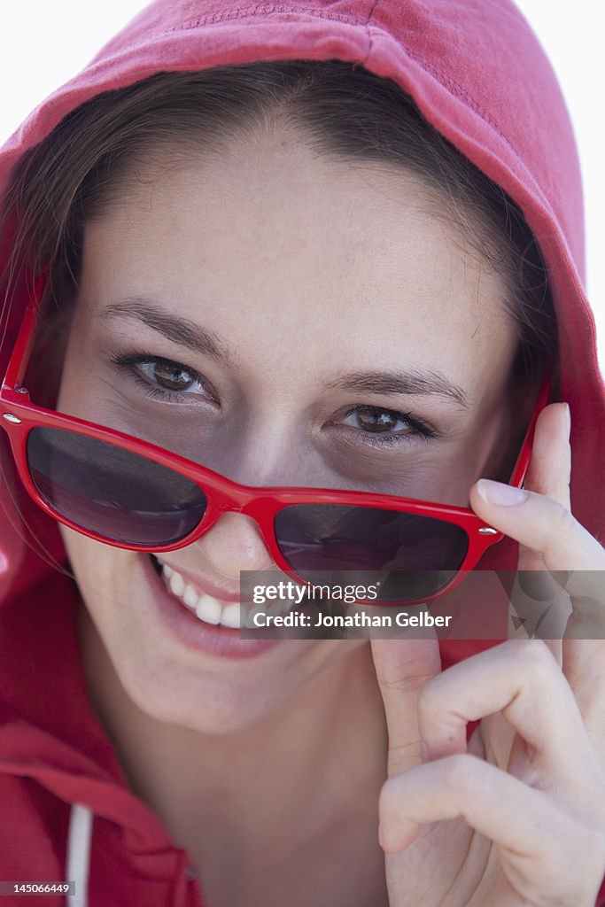 Portrait of girl looking over her sunglasses