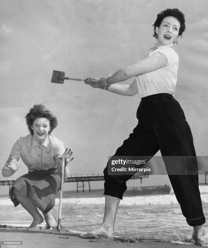 Holidaymakers play a game of cricket on the sands at Bournemouth April 1954